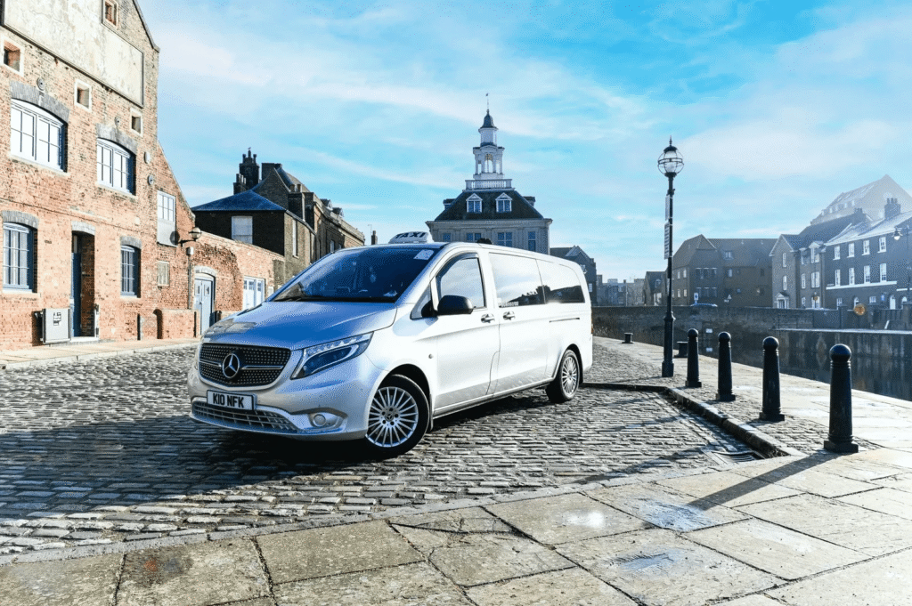 White van near historic building